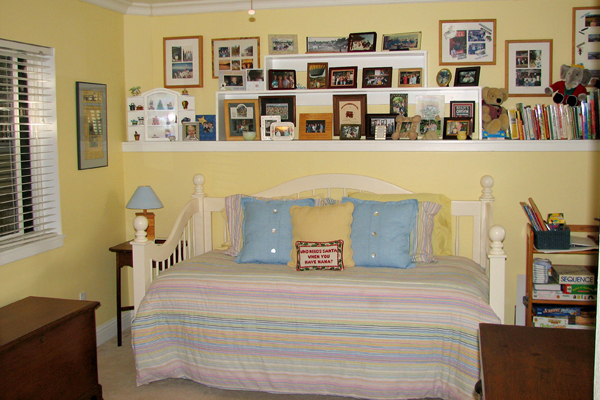 click to view larger image Family photographs above a daybed. Martinez Home Tour.